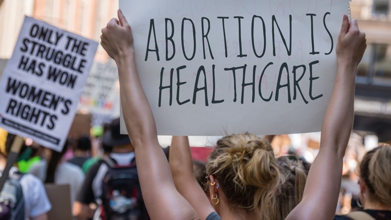 Protestor holding a sign reading 'Abortion is healthcare'