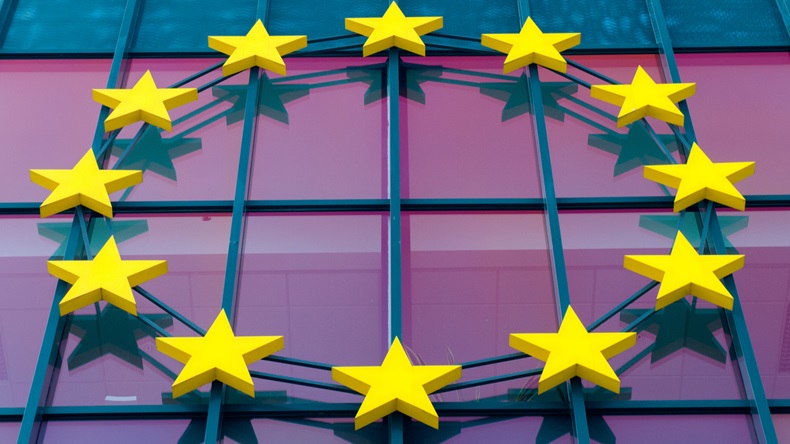 European Union stars symbol against violet glass building wall - Image 