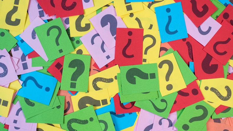 colorful paper with question mark as background. 